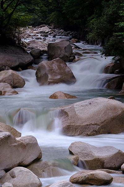 River rapids made peaceful using long-exposure photography to smooth out the rapidly flowing and cascading water. 